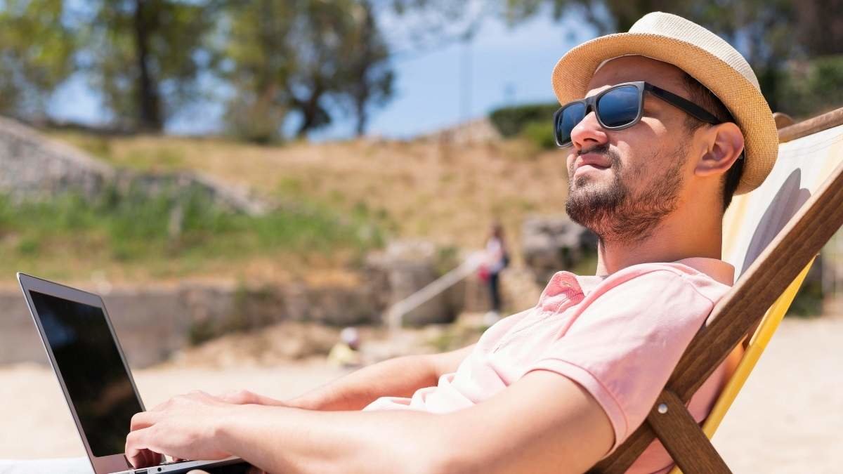 man-beach-chair-working-laptop (1)