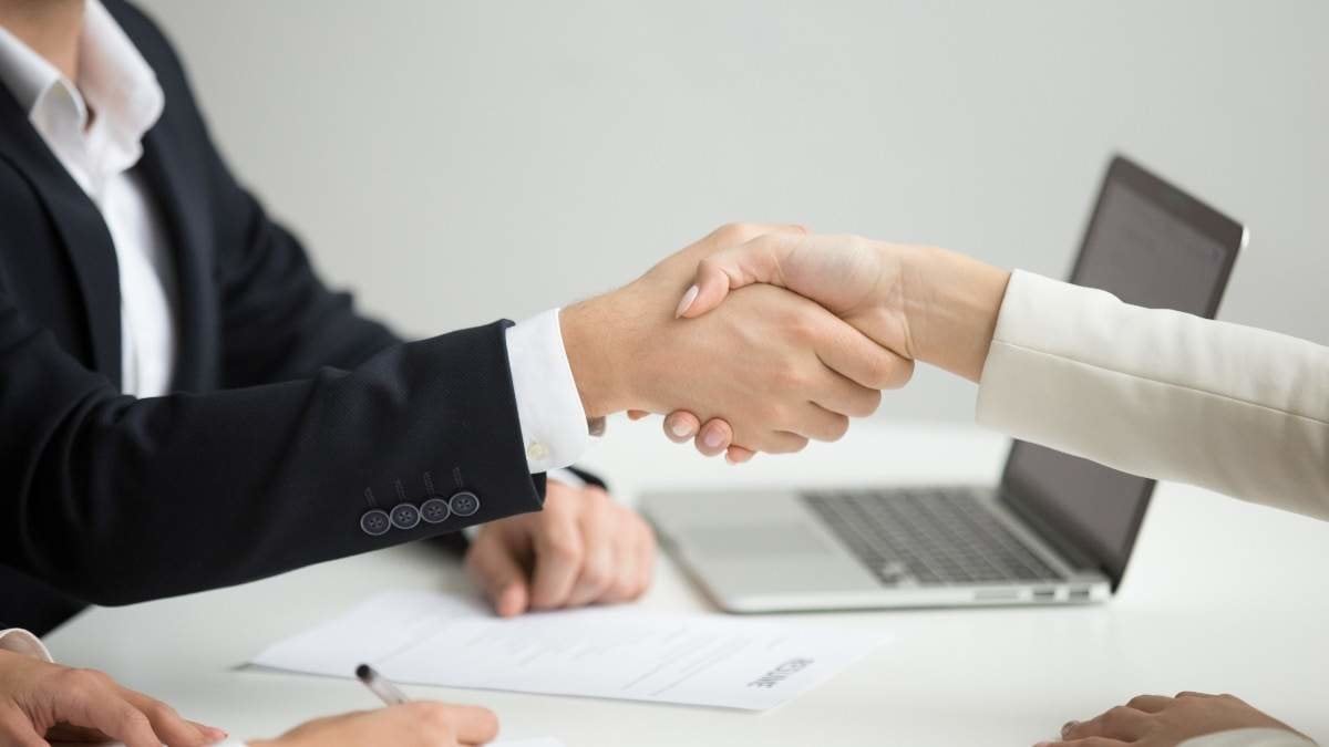 Employment handshake concept, female hr and successful woman candidate shaking hands getting hired ready to sign job contract concept, employer congratulating welcoming new worker, close up view