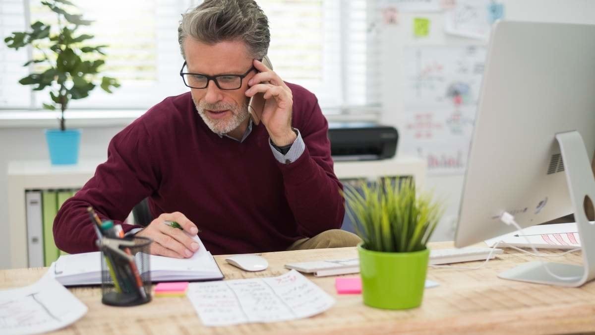 Man talking on the phone with one of his clients