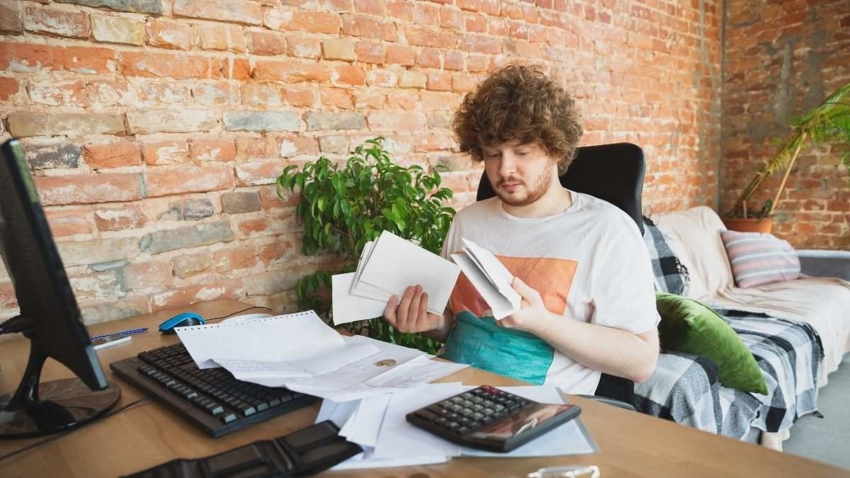 Caucasian upset and despair man doing financial and economical reports